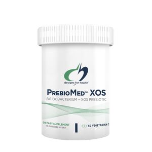 A container of PrebioMed XOS dietary supplement, with the label indicating it is a 'Bifido-Bacterium Probiotic' and 'Vegan'. The container is white with green and blue accents, and it is labeled as 'Dietary Supplement'.